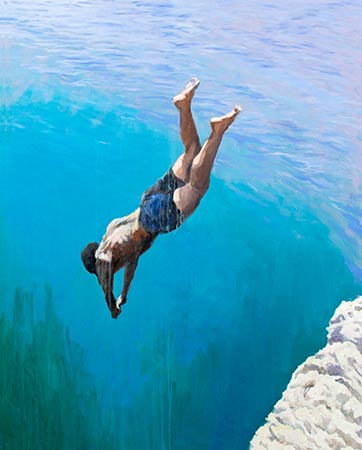 Solitary diver plunging into an electric blue sea from rocky cliffs